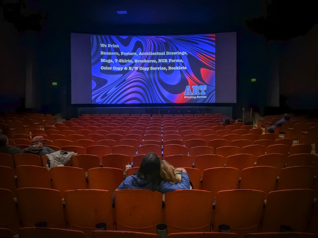 Audience waiting for a movie to begin inside Gardena Cinema auditorium