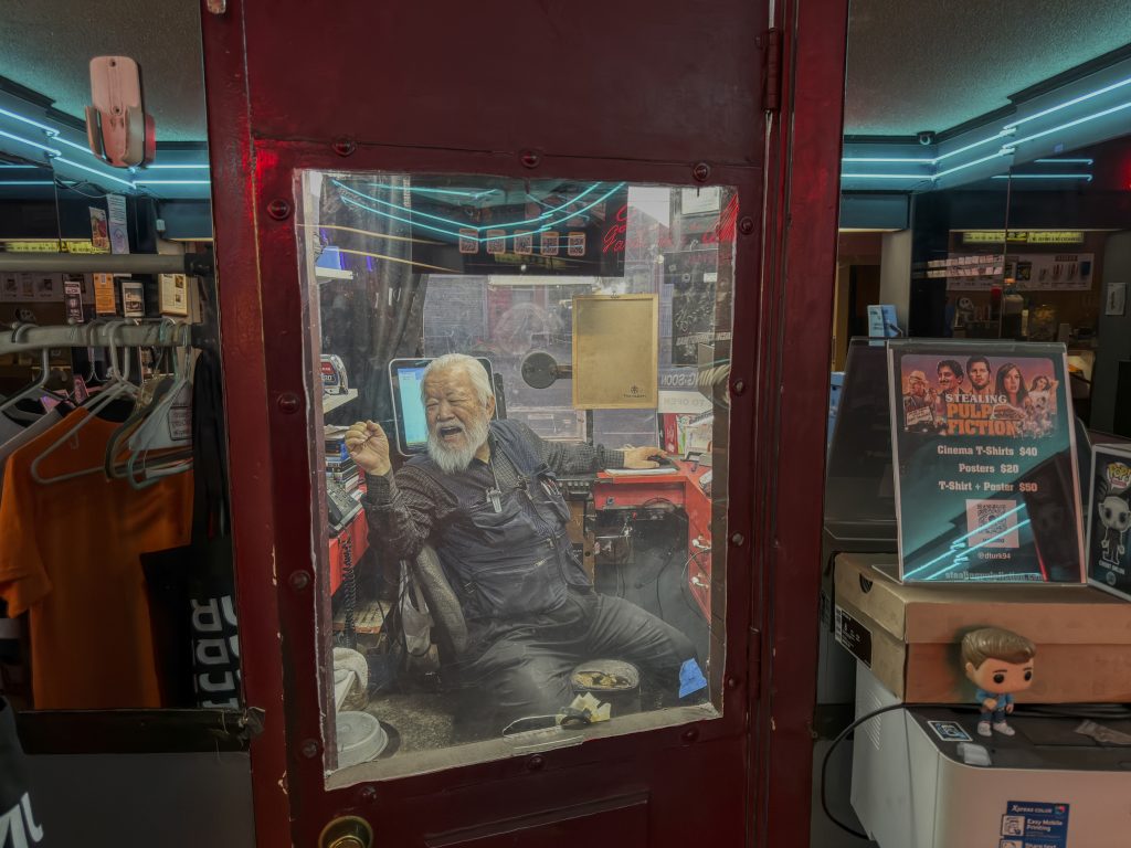 John Kim laughing inside the box office at Gardena Cinema while talking to Judy Kim