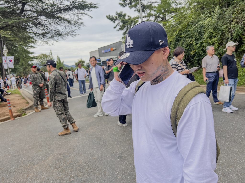 K.Y. makes a phone call to his wife in Los Angeles before Army enlistment