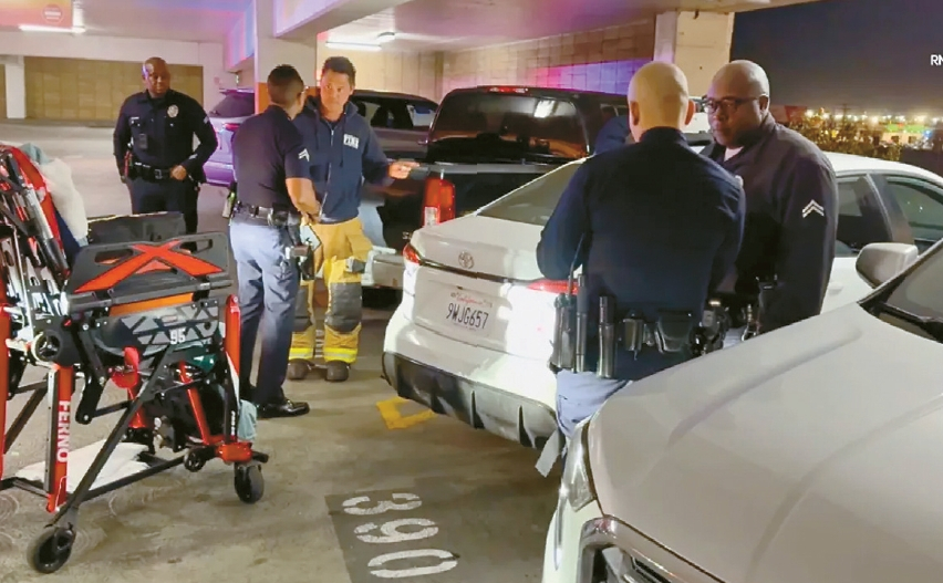Police investigate the scene after an armed robbery involving pepper spray at a long-term parking facility near LAX. [KTLA capture/RMG News]