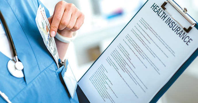 ACA premium hikes as a doctor holds a patient chart during a medical consultation