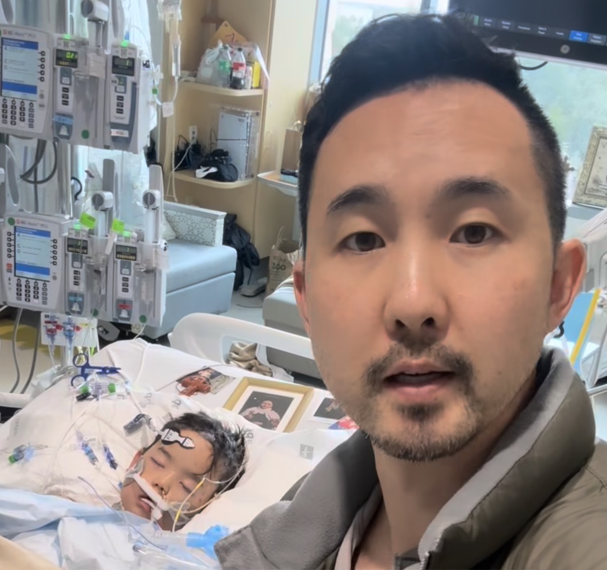 Korean American influencer Paul Kim with his son Micah lying in a hospital bed during medical treatment