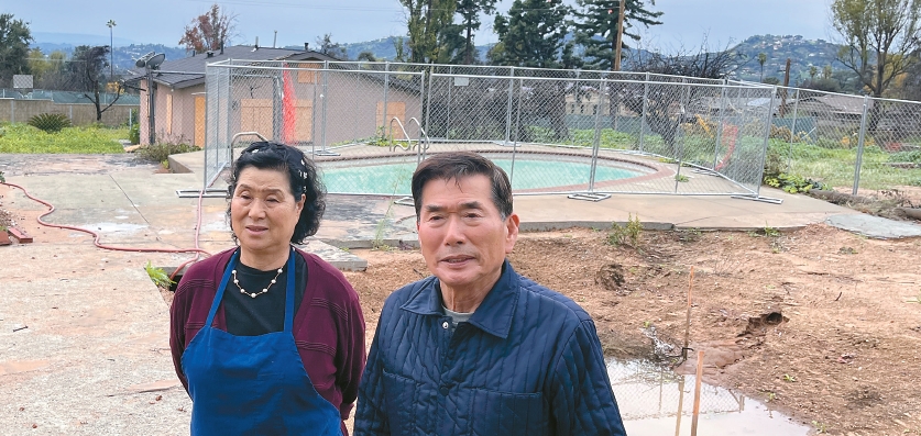 Lee Ki-sun and Yoo Jeong-ja stand on their cleared property one year after the Eaton Fire recovery efforts began in Altadena.