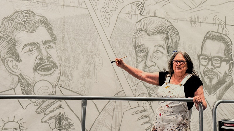 Judy Baca, who faces allegations of embezzling $5 million, participates in work on “The Great Wall of Los Angeles” mural in 2023.  [Sangjin Kim, The Korea Daily]
