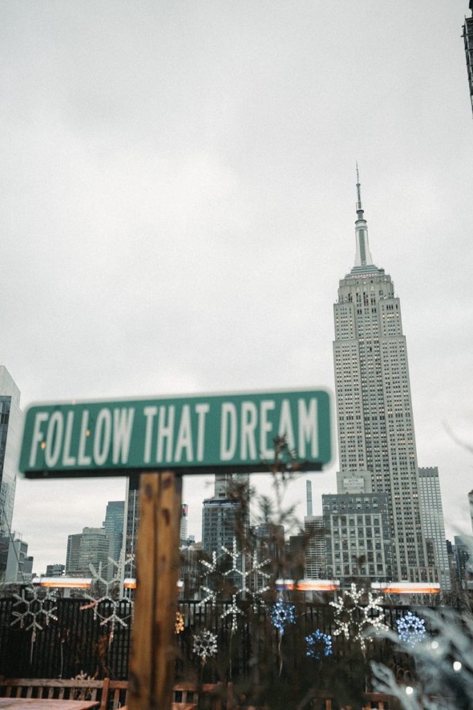 a street sign that reads follow that dream