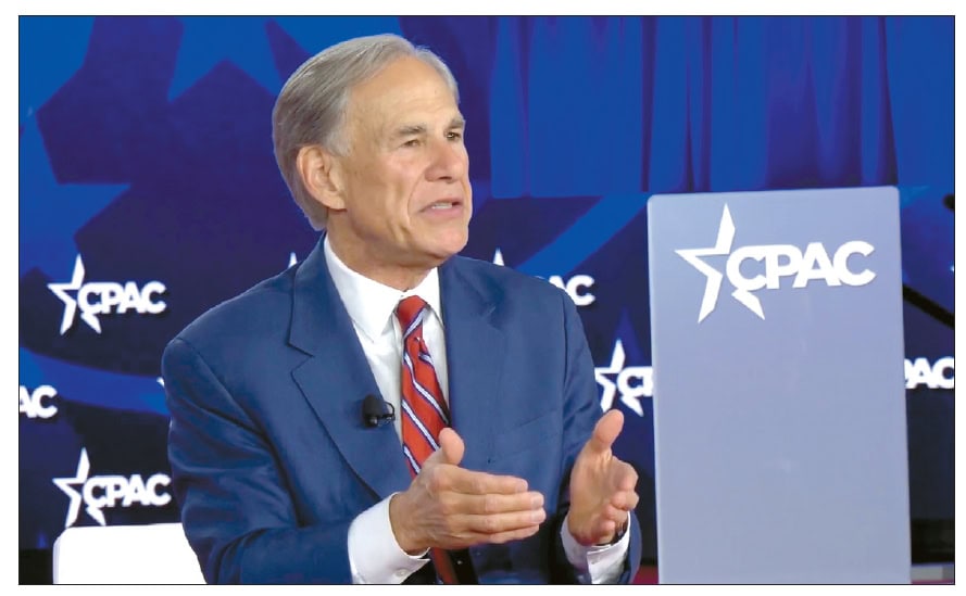 Texas Governor Greg Abbott speaking at a podium with CPAC branding in the background during a speech on conservative policies and crime.