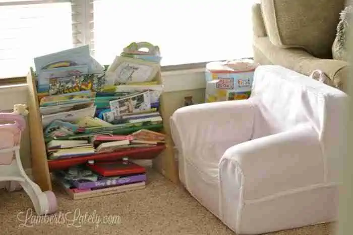 reading area in a playroom, with chair and bookshelf.