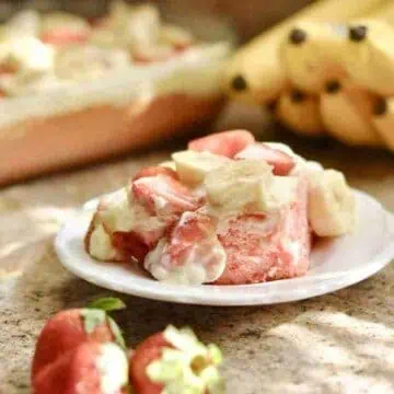 piece of strawberry banana pudding cake on a plate.
