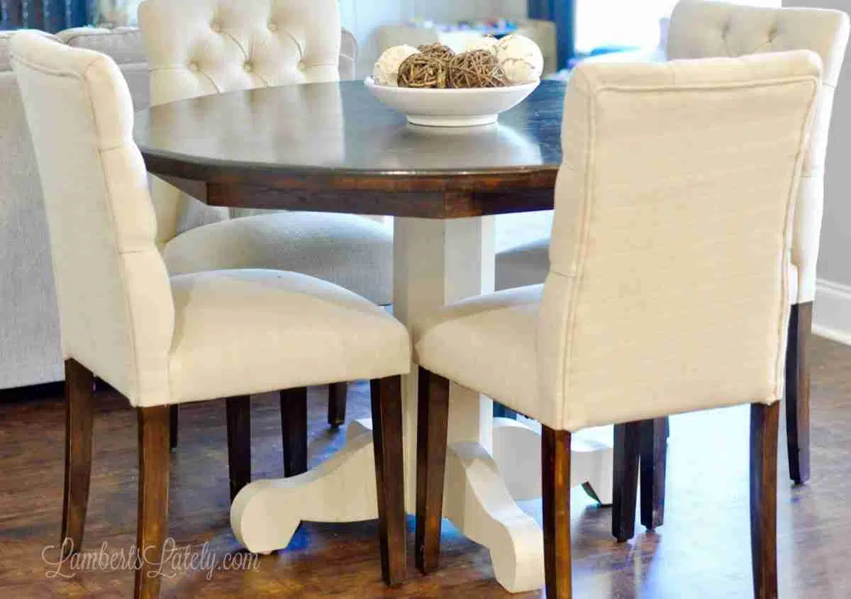 farmhouse kitchen wood table with chairs around it.