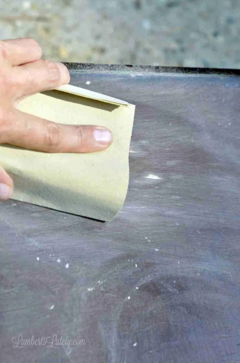 sanding a wood table.