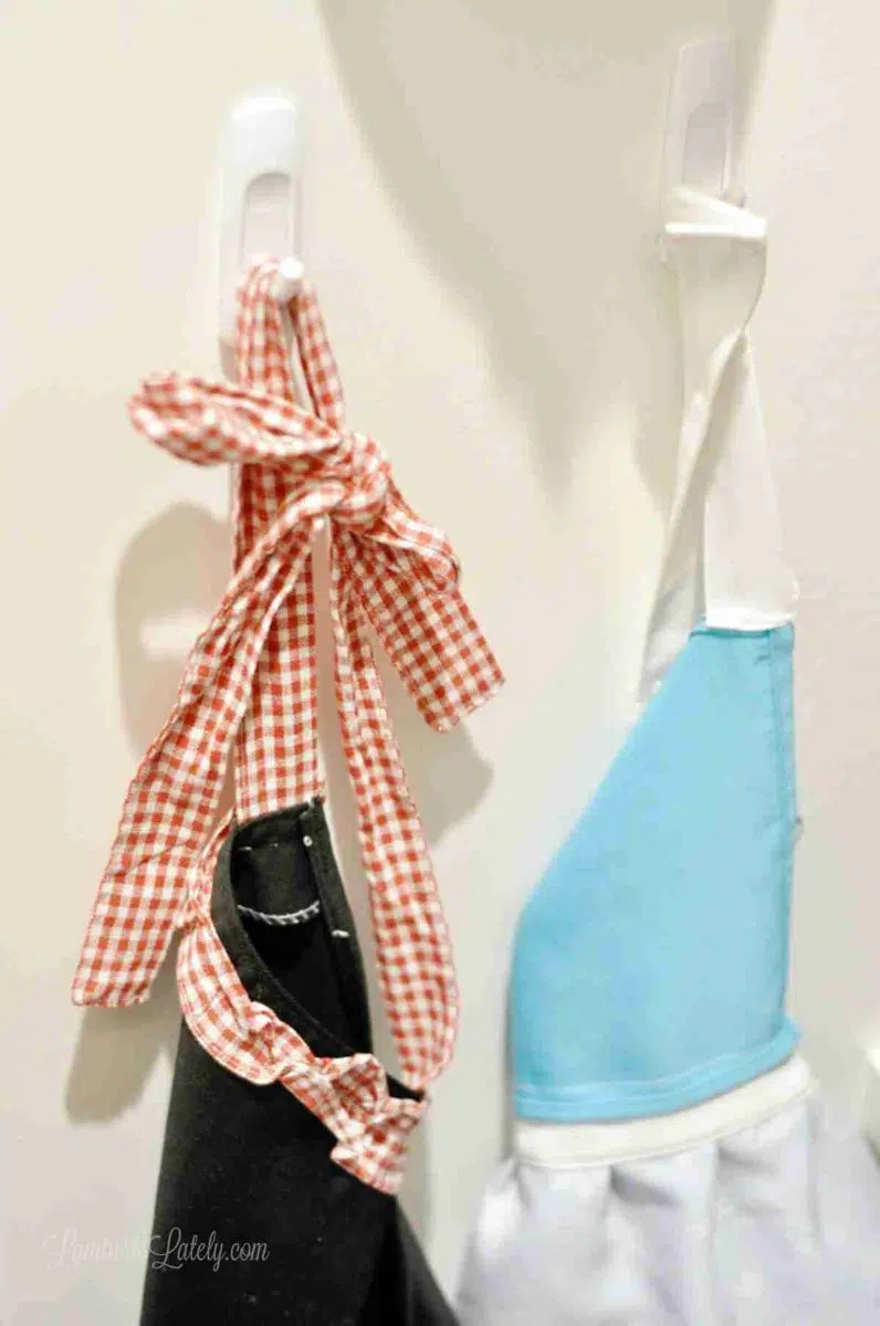 plastic pegs holding cooking aprons.