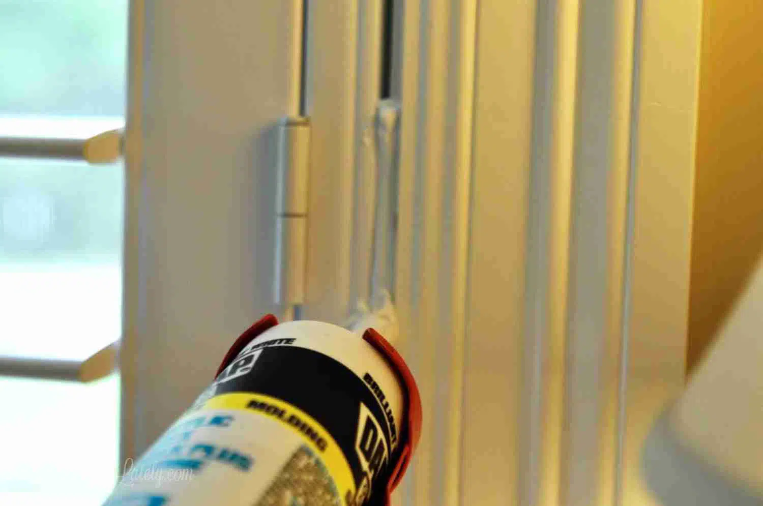 caulking gap between plantation shutter frame and window frame.