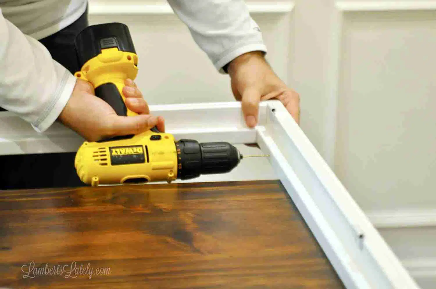 drilling a pilot hole in the plantation shutter frame.
