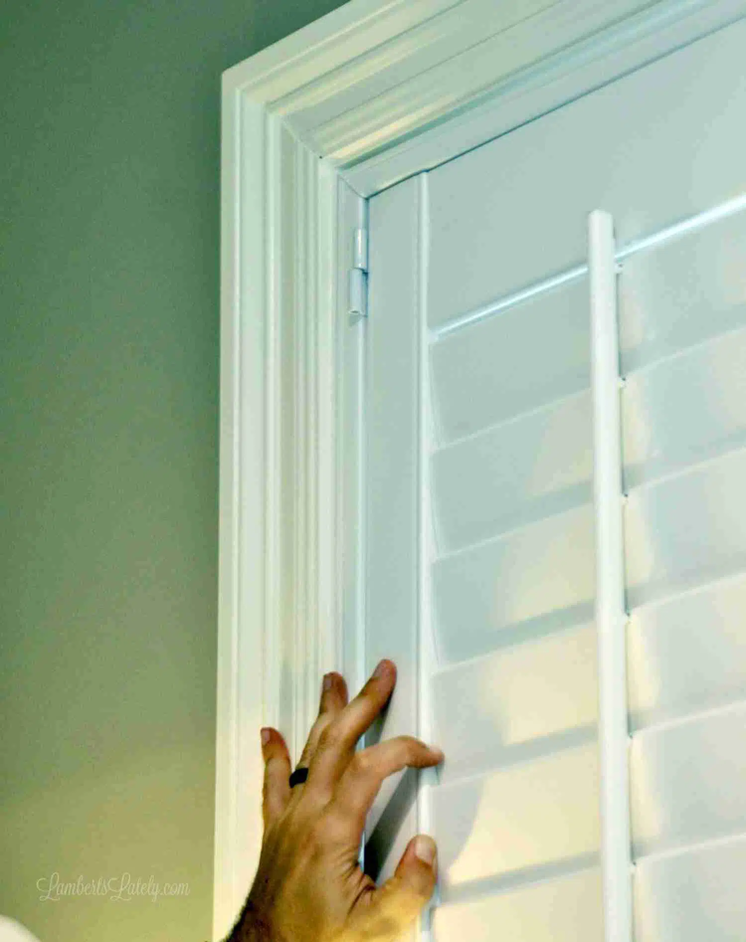 lining up hinge holes on blinds and frame.
