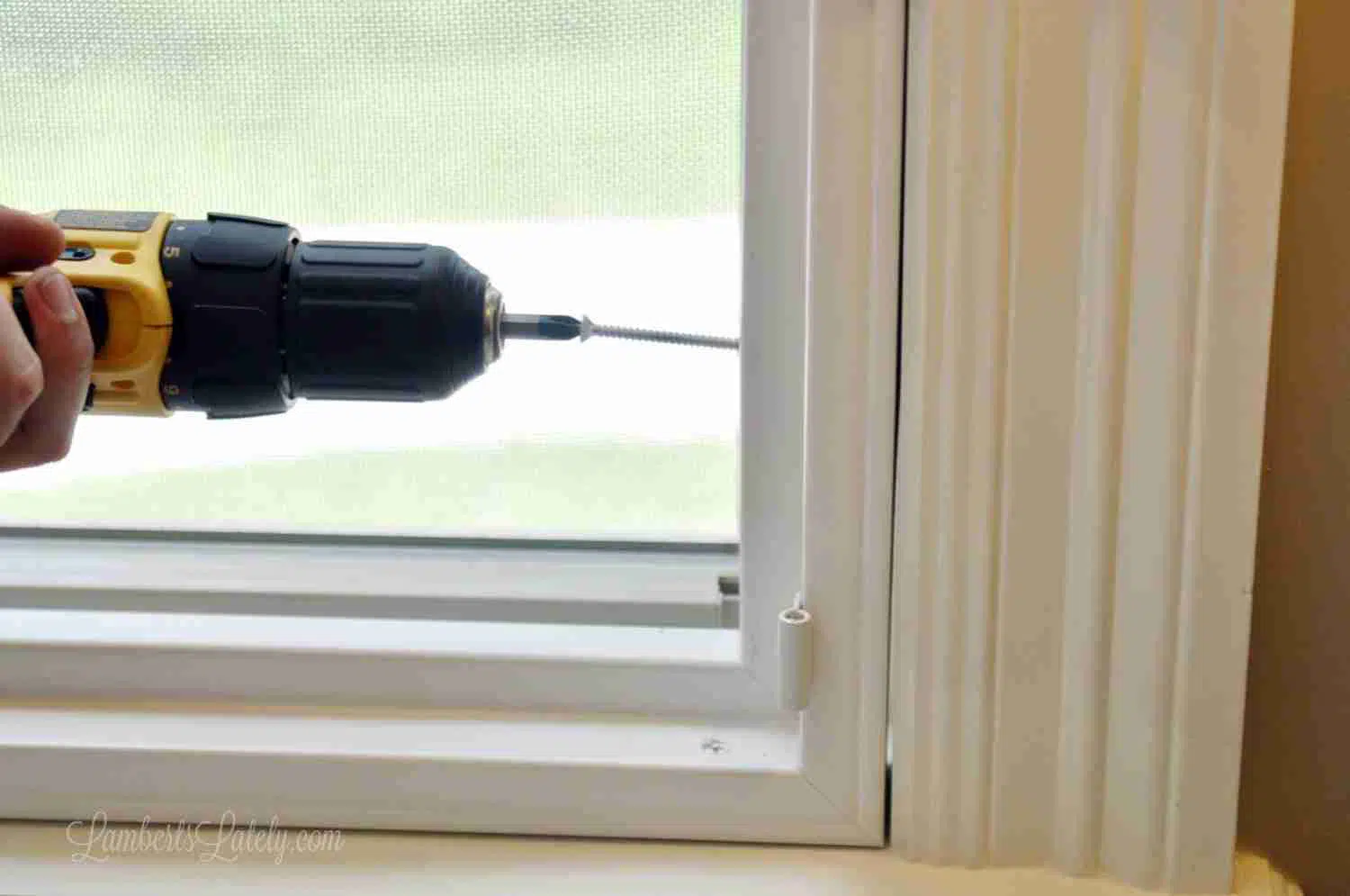 screwing into frame with a drill.