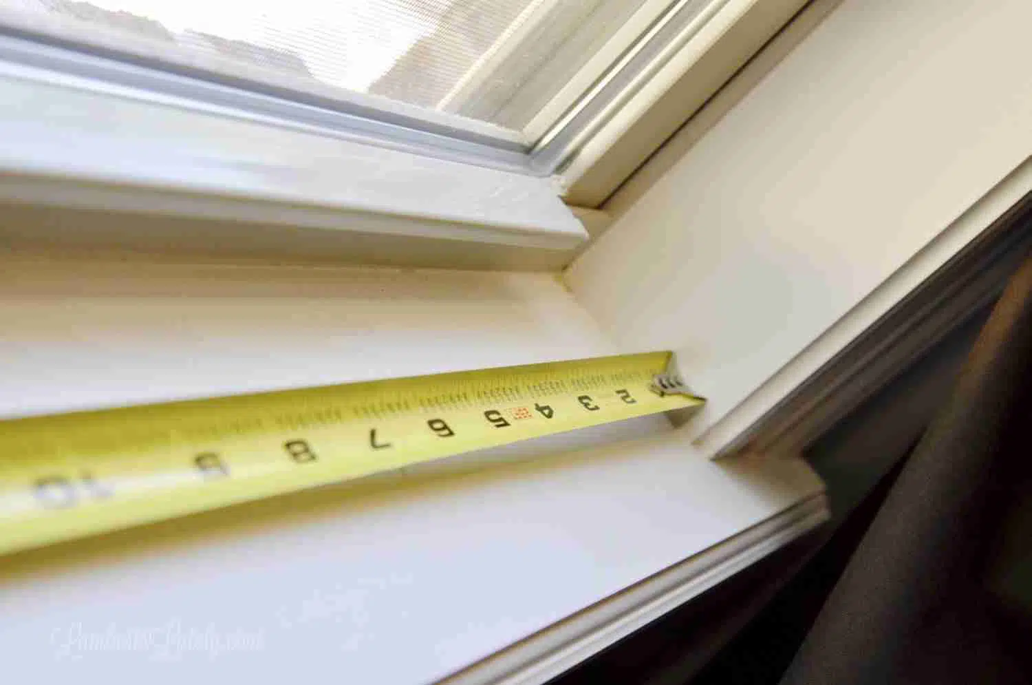 metal measuring tape in a window sill.