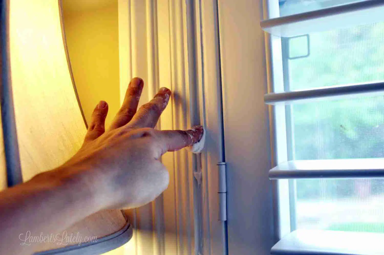 wiping excess caulk away with finger.