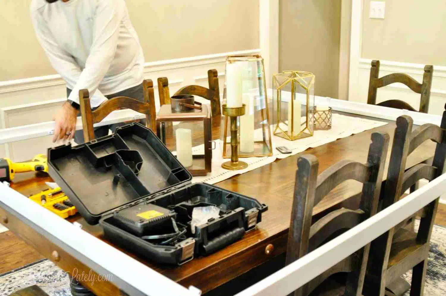 shutter frame on a dining room table with power tools.