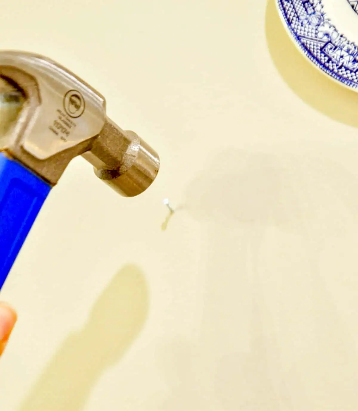 hammering a nail into the wall.