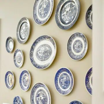 blue and white plates hanging on a wall.