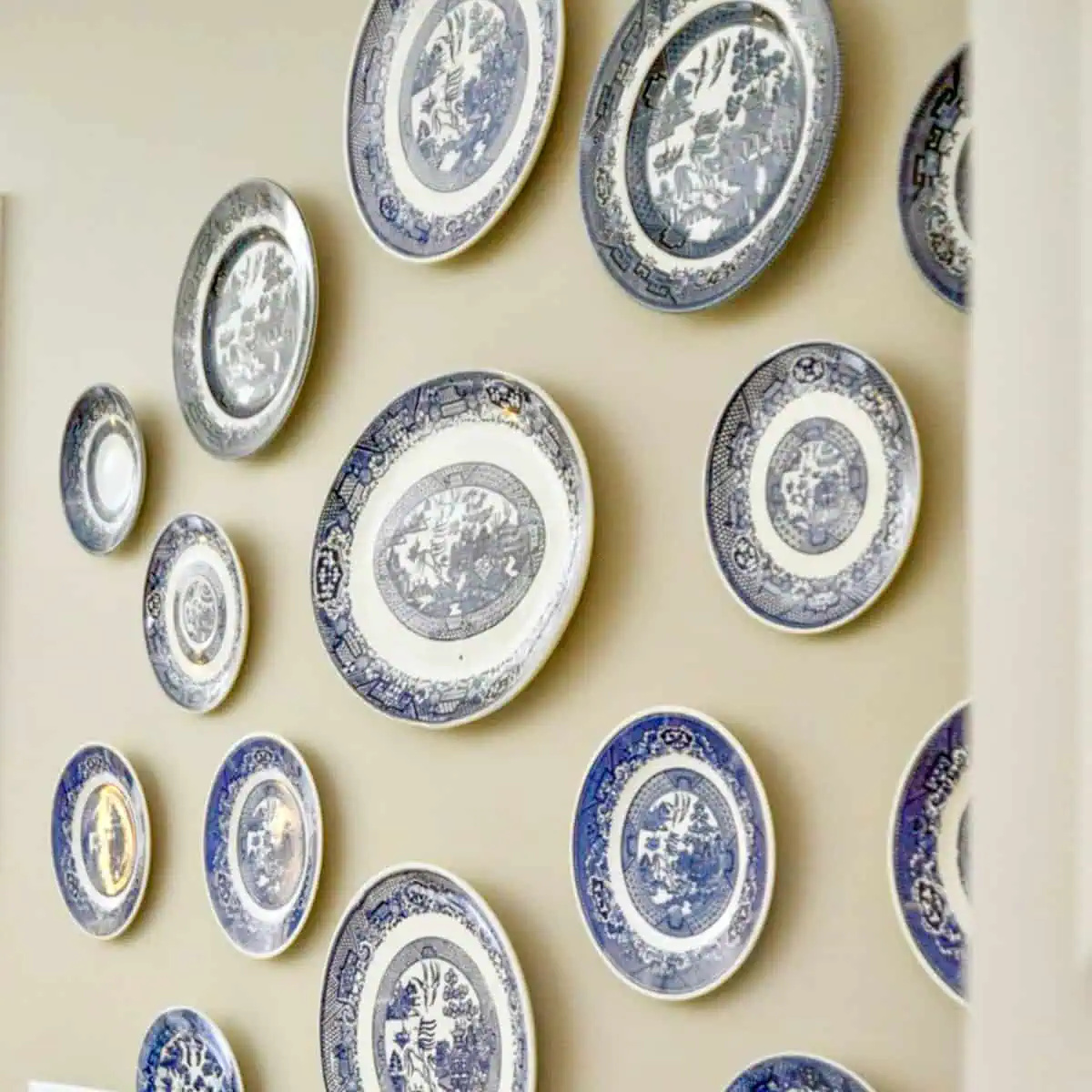 blue and white plates hanging on a wall.