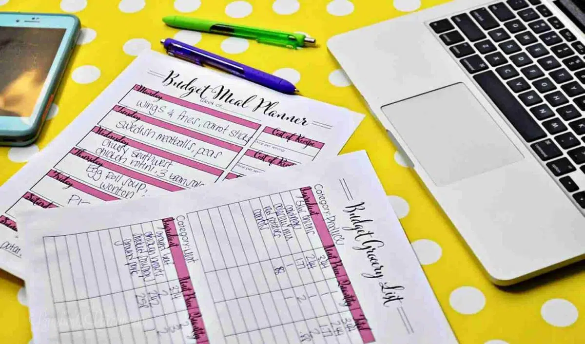 budget meal plans in front of a computer.