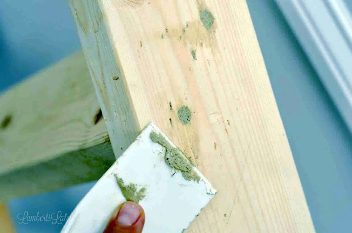 putting wood filler into screw holes on 2x4.