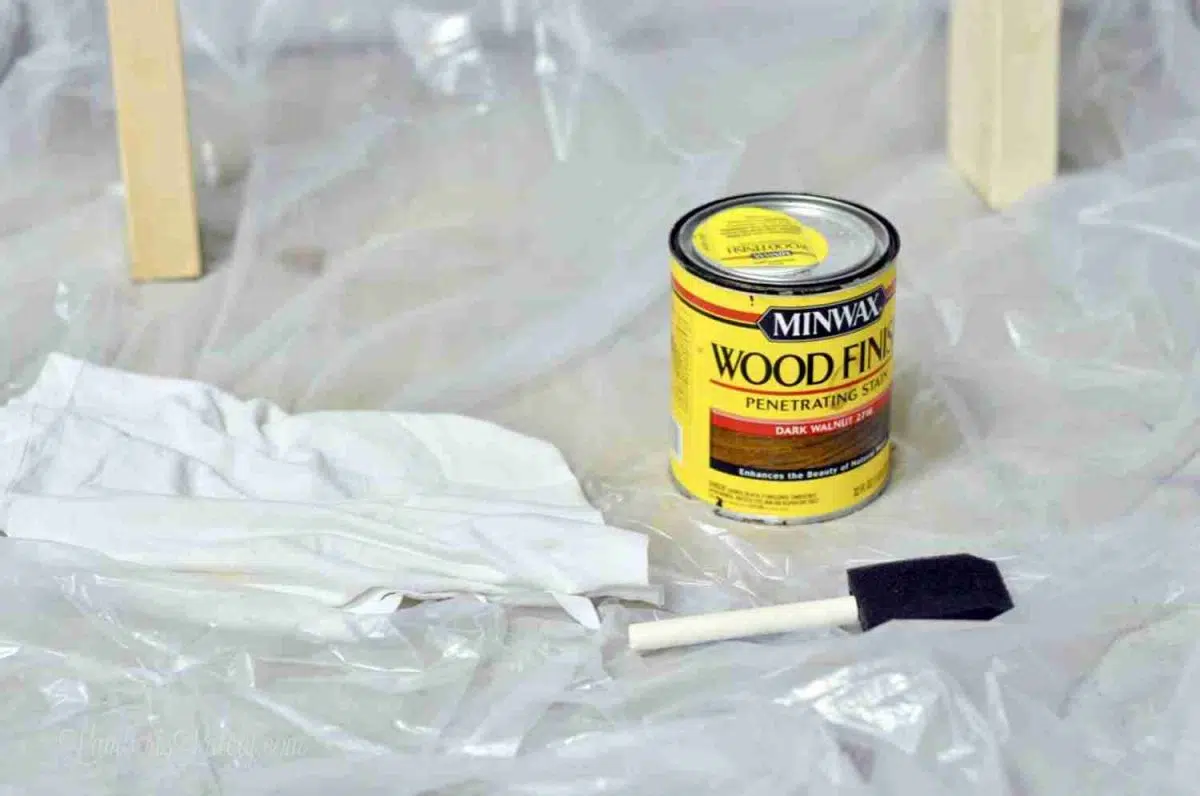 wood stain, brush, and drop cloth.