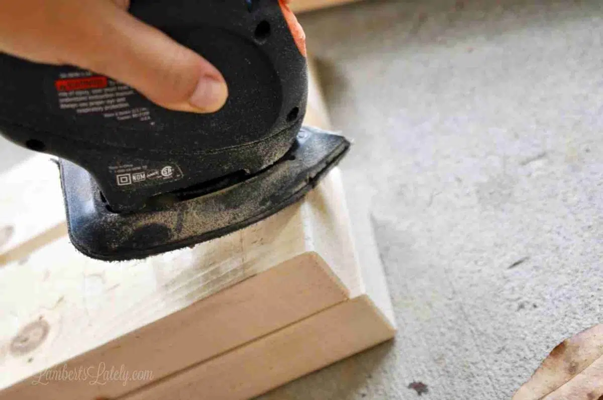 sanding corner of a 2x4 with an orbital sander.