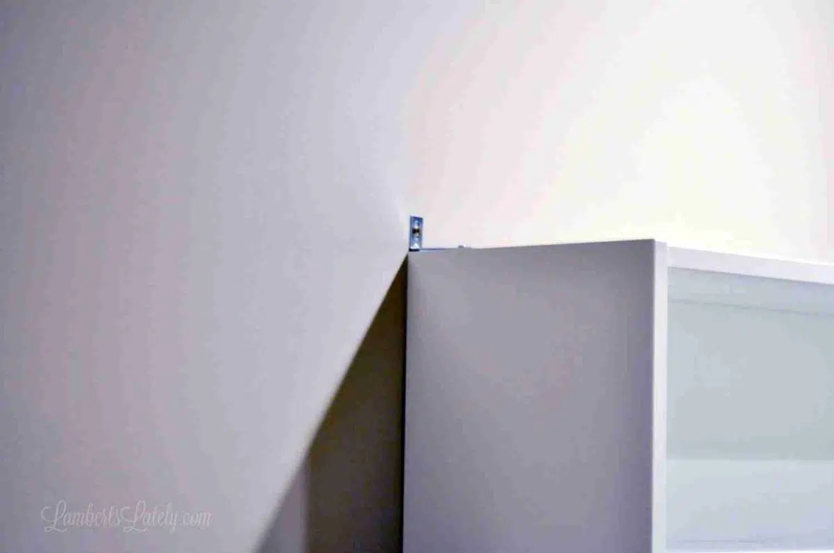 metal brace installed on top of cabinet.