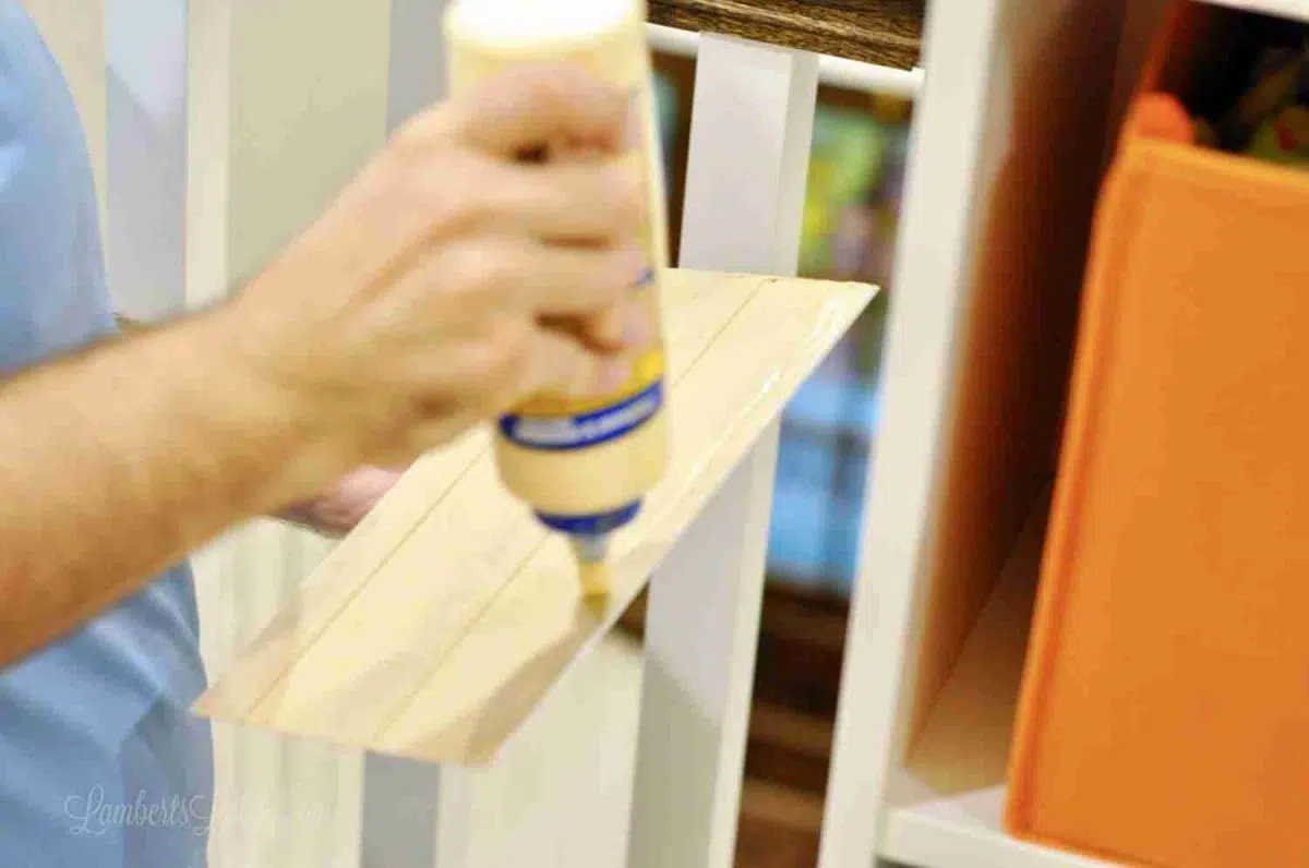 putting wood glue on back of baseboard.