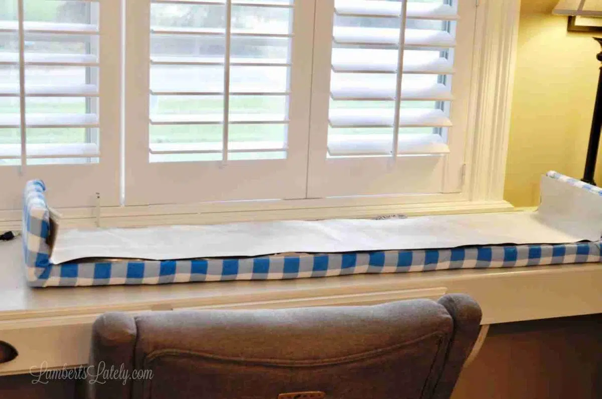 solid fabric draped over back of cornice board to cover tape.