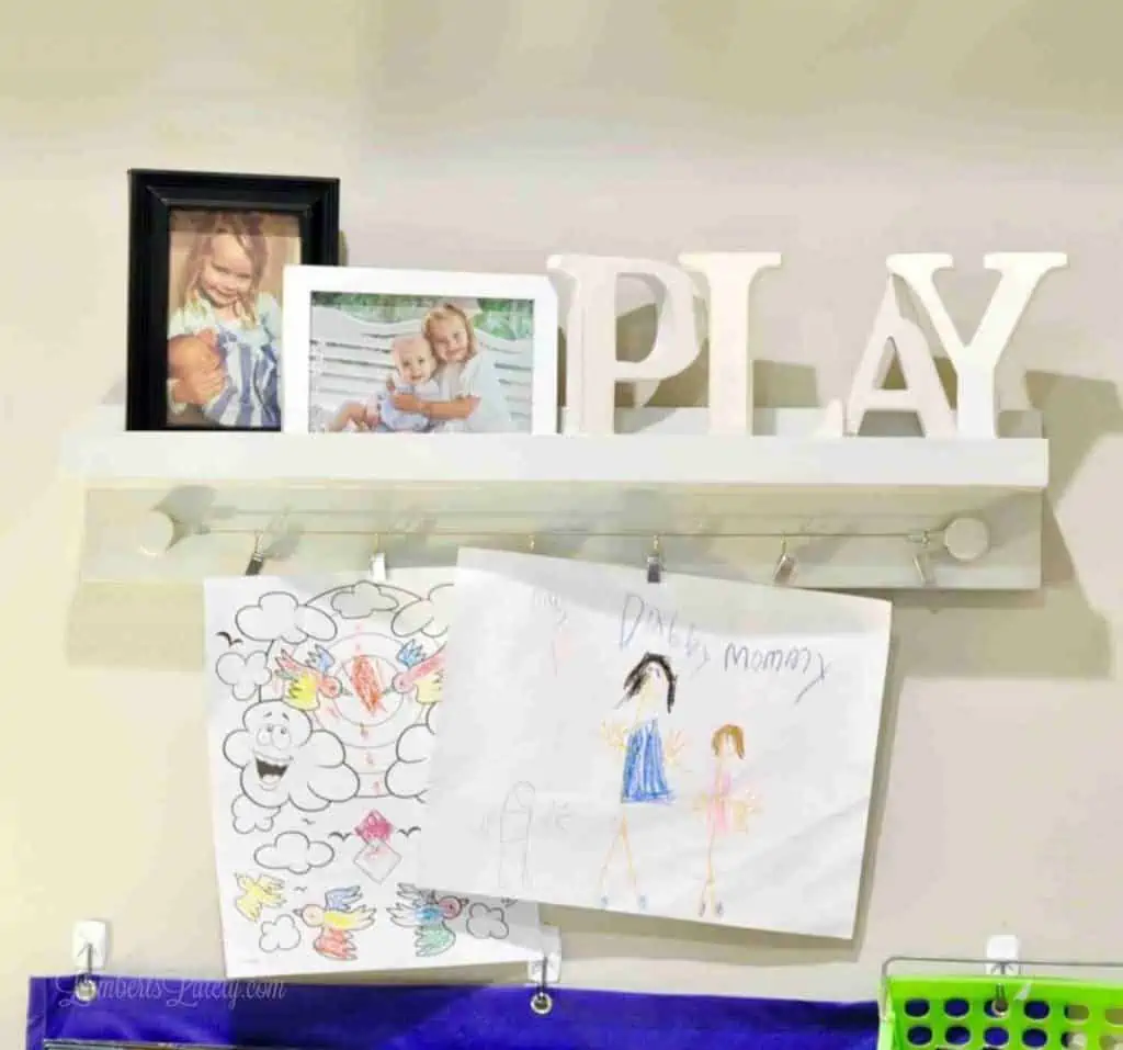 photos, art, play letters on a shelf.