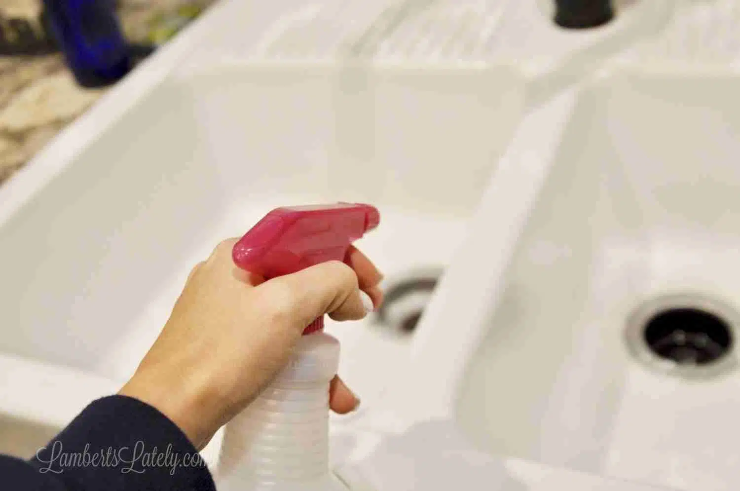 spraying sink with vinegar.