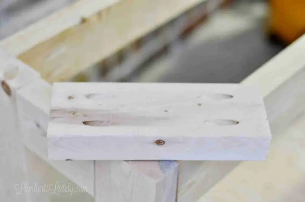 small piece of wood with four pocket holes in the corners.