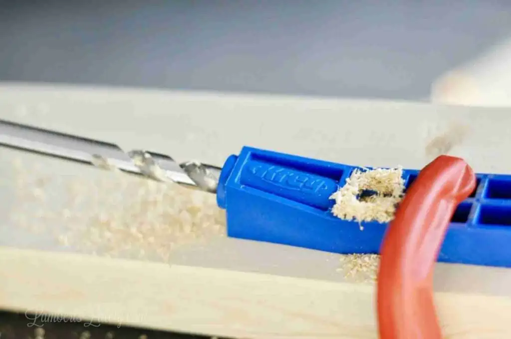 using a jig to drill a pocket hole.