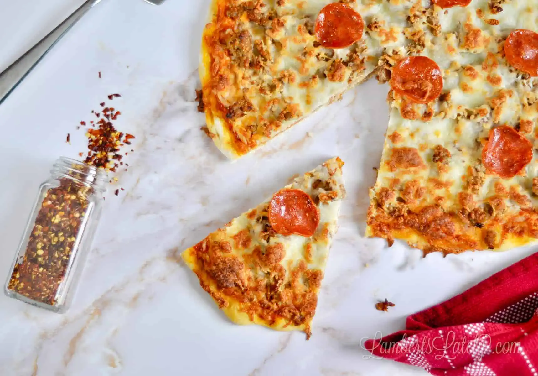 pizza with slice missing on a marble background.