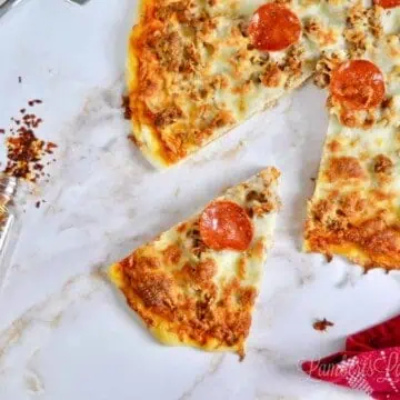 pizza with slice missing on a marble background.