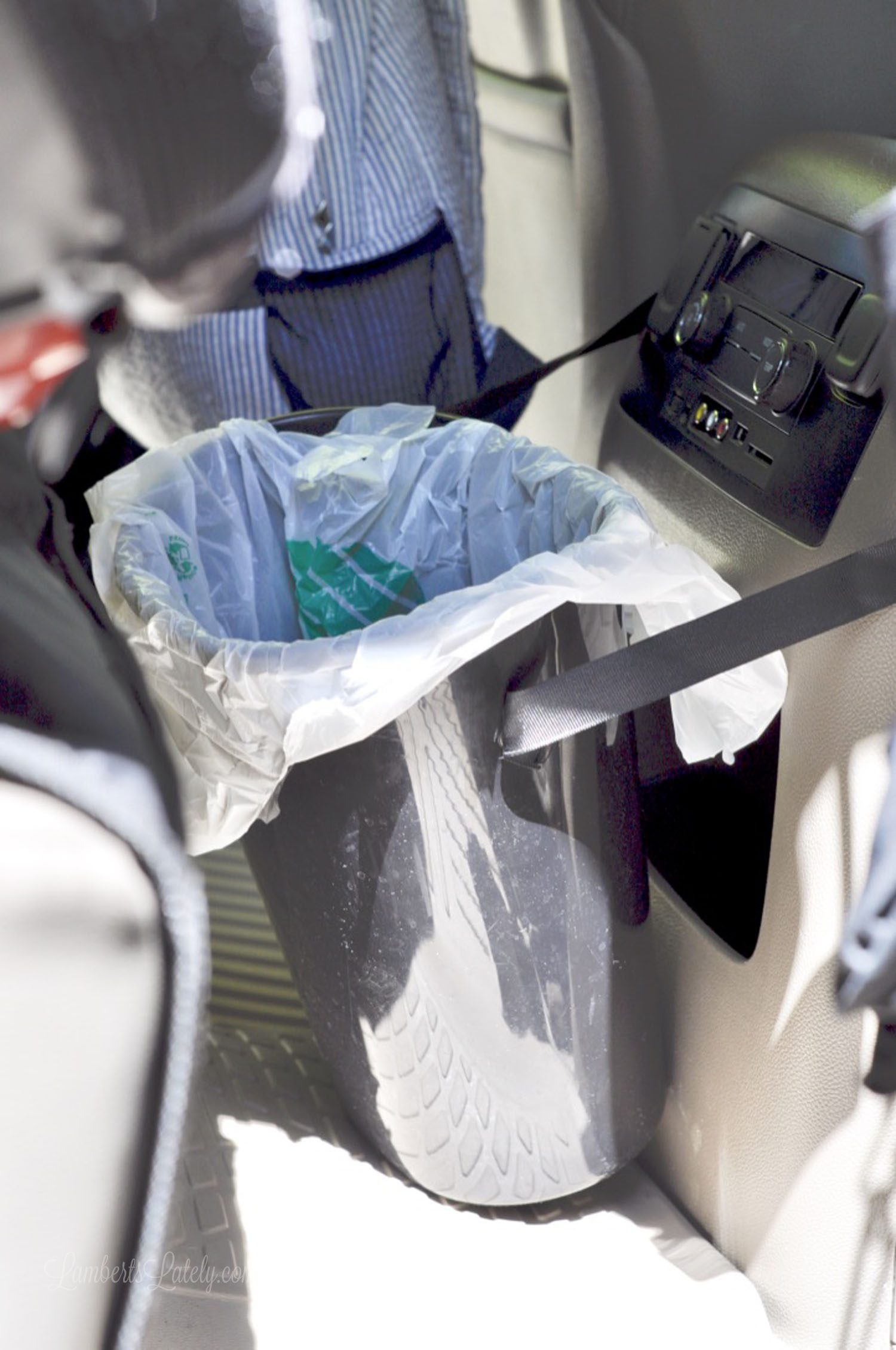 trash can attached to a center console in a car.