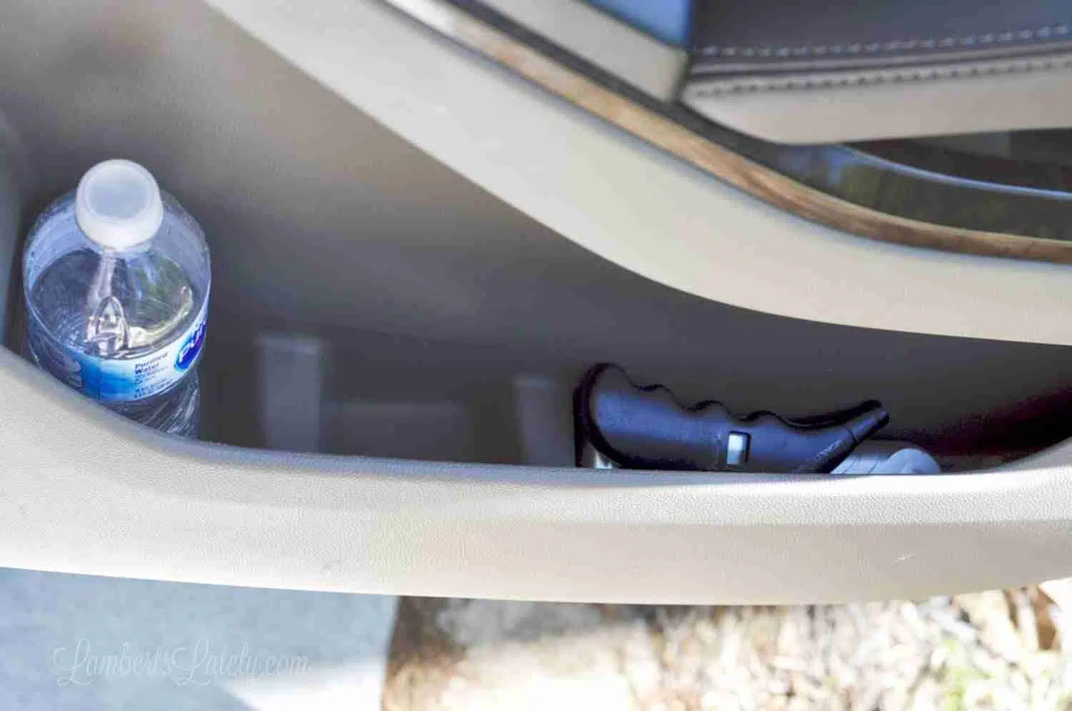 water bottle and window breaker in door storage in a car.
