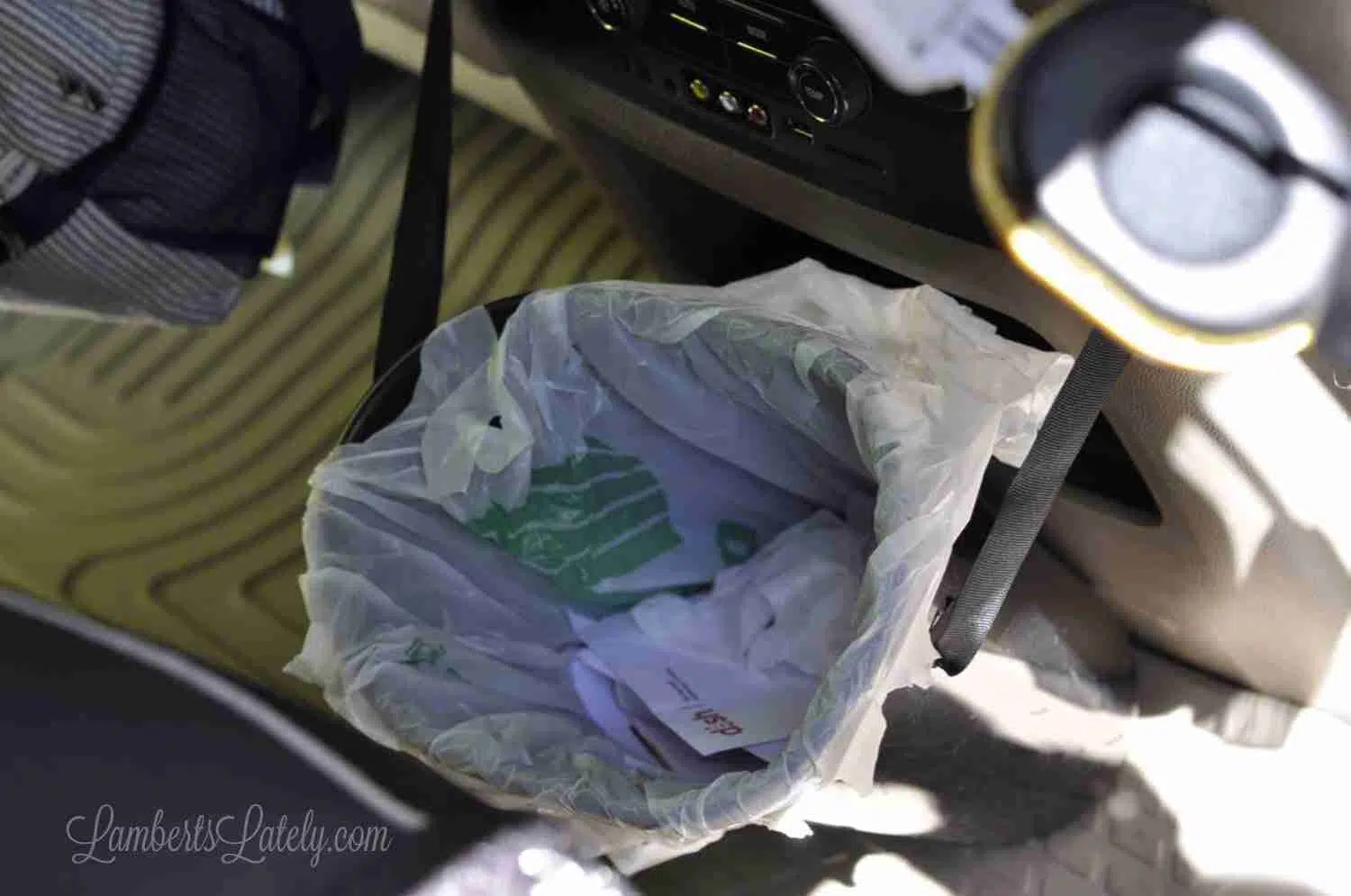 looking down on a trash can in a car.