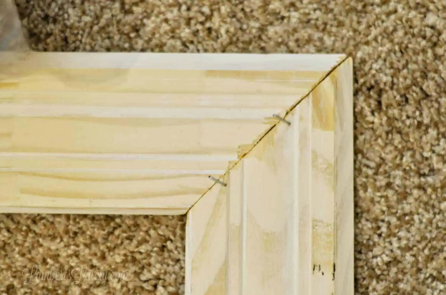 2 pieces of crown molding attached at 45 degree angles with staples.