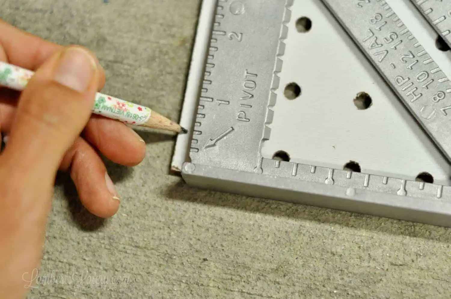 marking spot on a pegboard with a pencil.