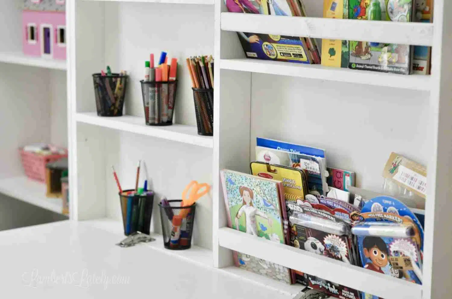 desk on front of murphy bed folded out, holding books and art supplies