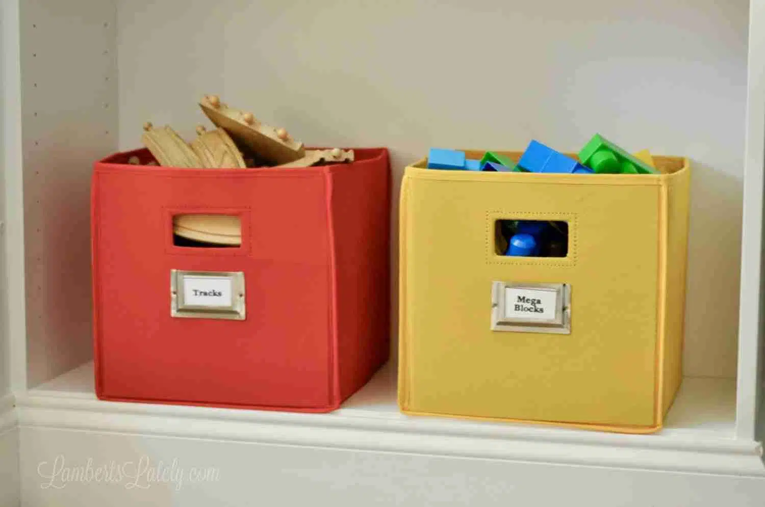 red and yellow fabric bins holding toys on a shelf
