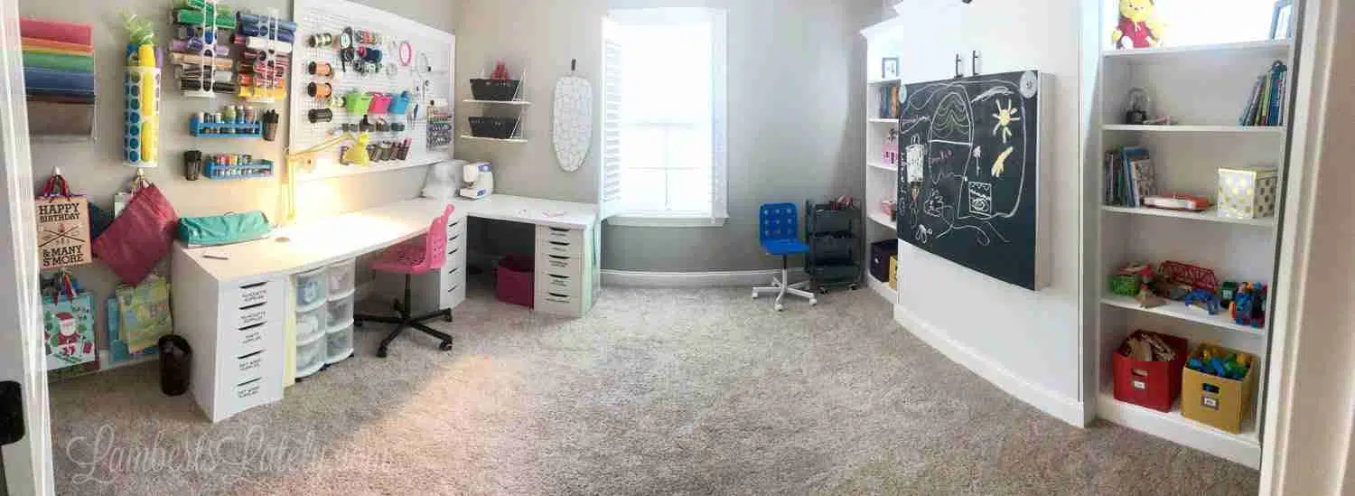 wide angle view of an entire craft room and murphy bed combo