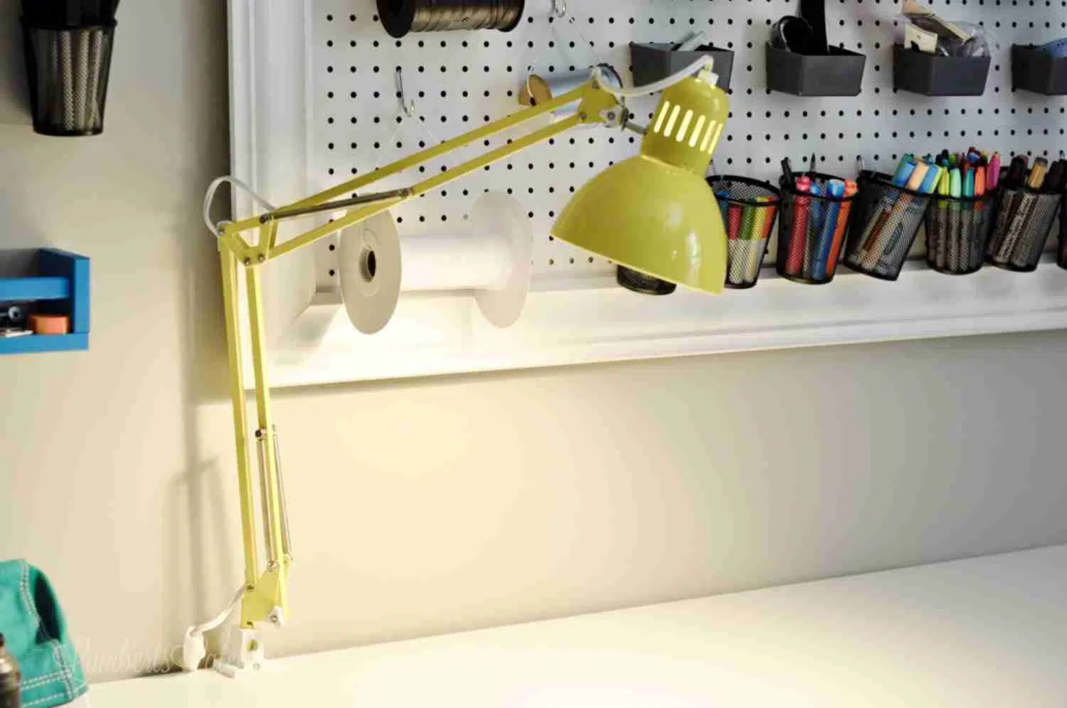 yellow swivel light attached to a desk