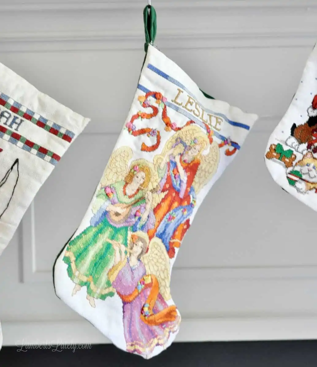 stocking with angels hanging from a mantle.