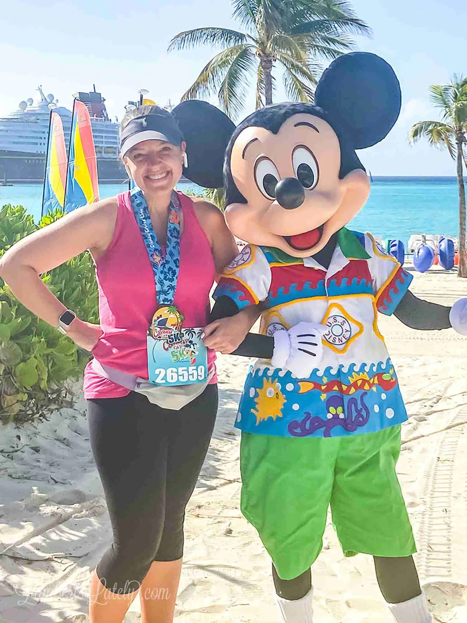 With Mickey Mouse after Castaway Cay 5k, with Disney wonder in the background.