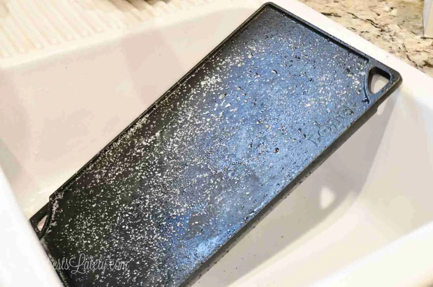 cast iron griddle in a sink